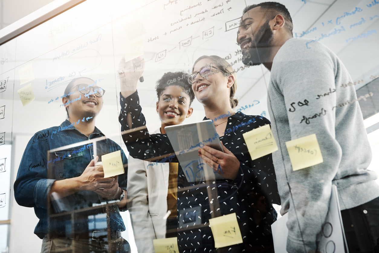 A group of diverse business owners in a modern office brainstorming about marketing strategies.